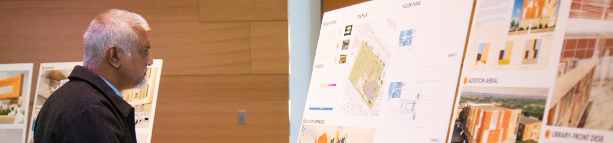 Attendee of the 2017 Austin ISD Bond update event viewing school plans.