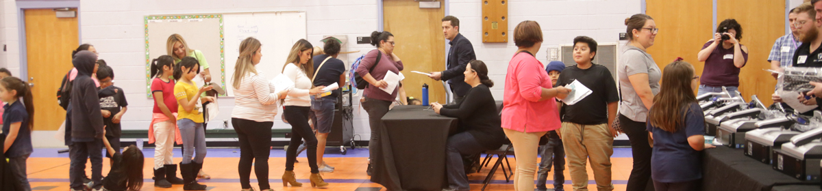 Photo of AISD families in line for a computer.