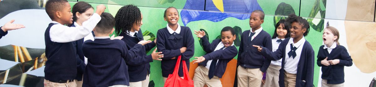students celebrate their artwork being on city buses