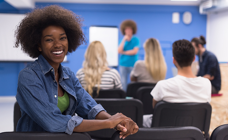 African American community member smiling and group engaged in discussion.