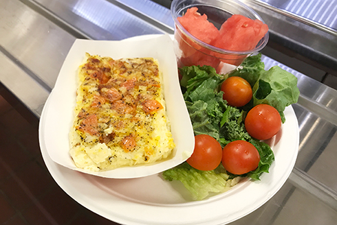 Large portion of tomato frittata with side salad on a plate
