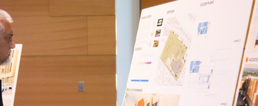 Attendee of the 2017 Austin ISD Bond update event viewing school plans.