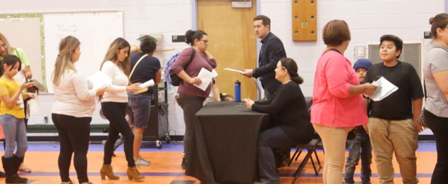 Photo of AISD families in line for a computer.