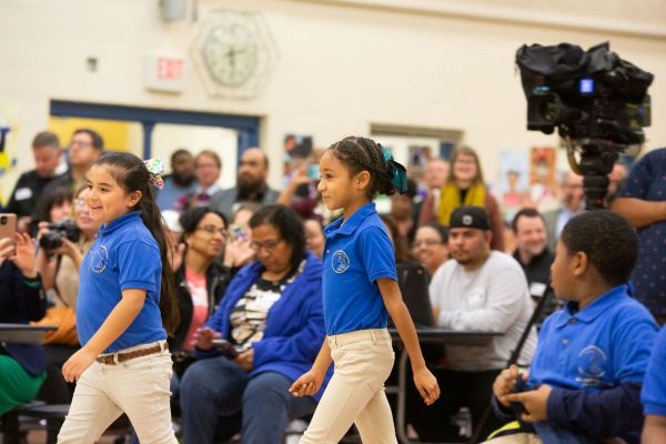 Student artist winners walk up to stage